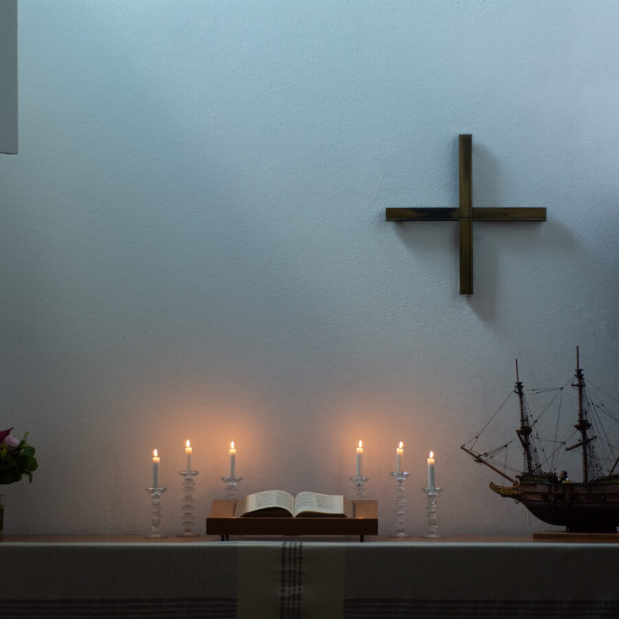 Raamattu ja palavat kynttilät merimieskirkon alttariila